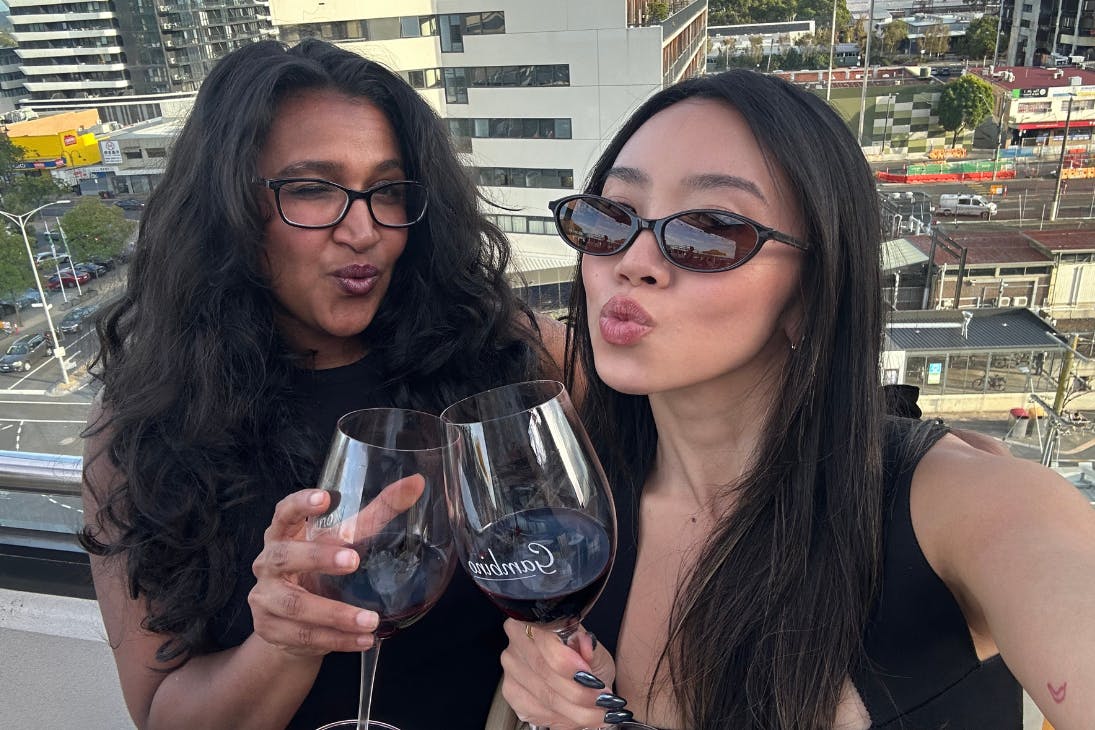 Two young women drinking wine